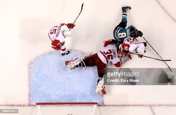 Jimmy Howard of the Detroit Red Wings makes a save while Nicklas Lidstrom and Niklas Kronwall play defense on Joe Pavelski of the San Jose Sharks in...