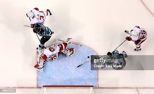 Jimmy Howard of the Detroit Red Wings plays in the goal while Andreas Lilja and Niklas Kronwall play defense on Rob Blake and Manny Malhotra of the...