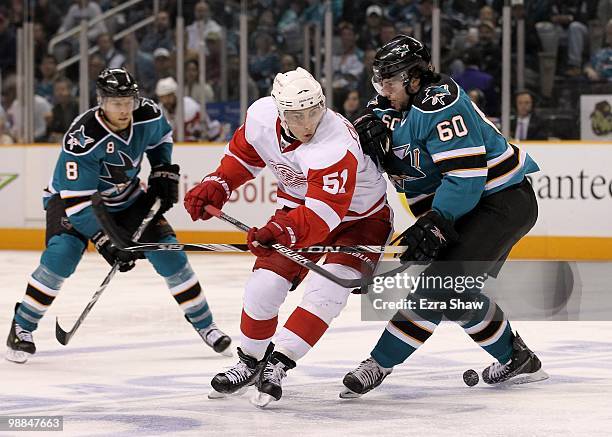 Jason Demers and Joe Pavelski of the San Jose Sharks defend against Valtteri Filppula of the Detroit Red Wings in Game Two of the Western Conference...