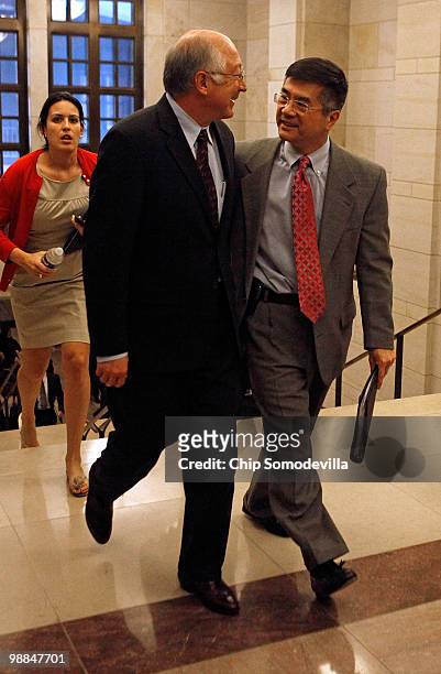 Interior Secretary Ken Salazar and Commerce Secretary Gary Locke leave with their arms around each other after briefing members of Congress about the...
