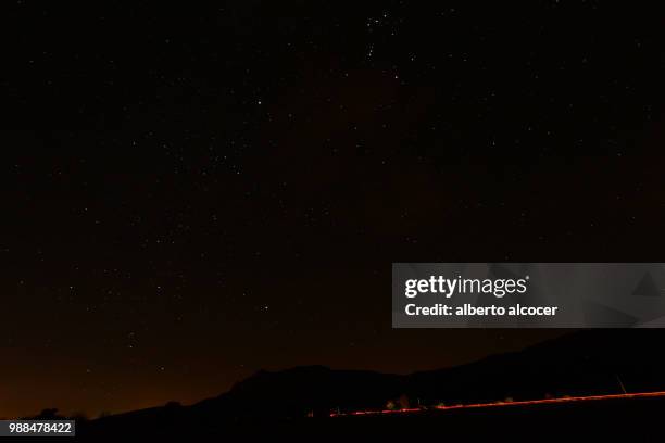 night landscape with passing by car - alberto alcocer imagens e fotografias de stock