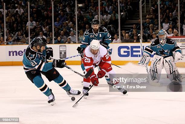Scott Nichol, Dan Boyle and Evgeni Nabokov of the San Jose Sharks defend against Jason Williams of the Detroit Red Wings in Game Two of the Western...