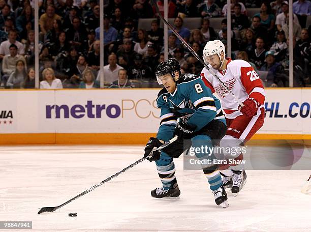 Joe Pavelski of the San Jose Sharks is defended by Brian Rafalski of the Detroit Red Wings in Game Two of the Western Conference Semifinals during...