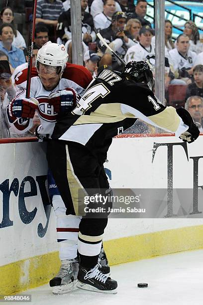 Chris Kunitz of the Pittsburgh Penguins finishes his check on Travis Moen of the Montreal Canadiens in Game Two of the Eastern Conference Semifinals...