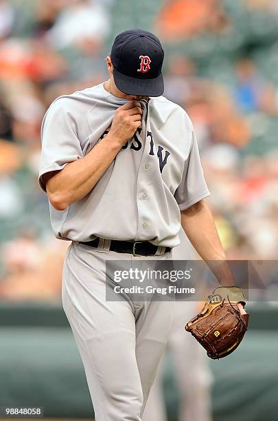 Jonathan Papelbon of the Boston Red Sox wipes his face during the ninth inning of the game against the Baltimore Orioles at Camden Yards on May 2,...