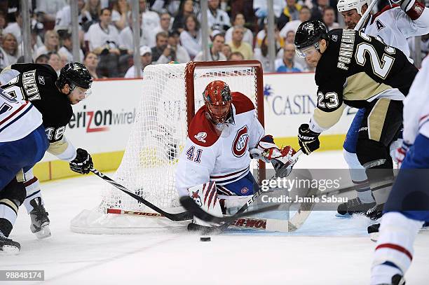 Goaltender Jaroslav Halak of the Montreal Canadiens thwarts attempts by both Tyler Kennedy and Alexei Ponikarovsky of the Pittsburgh Penguins to get...