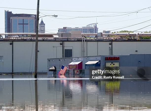 Businesses, including one with its American flag still flying, remain flooded May 4, 2010 in Nashville, Tennessee. More than 13 inches of rain fell...