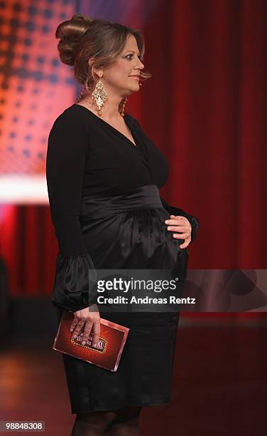 Pregnant TV host Barbara Schoeneberger reacts during the SKL show 'Tag des Gluecks' at Tempodrom on May 4, 2010 in Berlin, Germany.