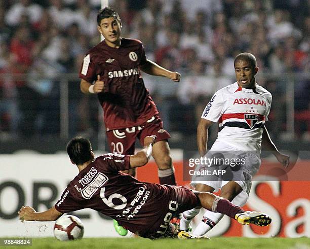 Peru's Universitario player Rainer Torres vies for the ball with Junior Cesar, of Brazil's Sao Paulo, during their Copa Libertadores football match...