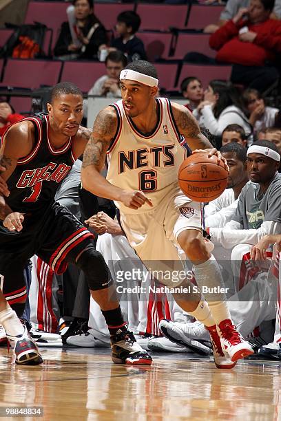 Courtney Lee of the New Jersey Nets moves the ball against Derrick Rose of the Chicago Bulls during the game at the IZOD Center on April 9, 2010 in...