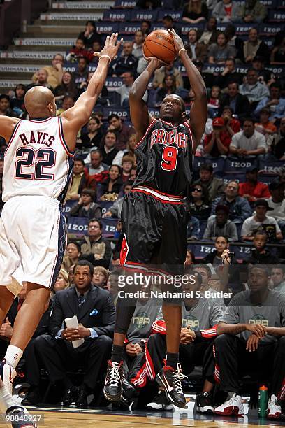 Luol Deng of the Chicago Bulls shoots a jump shot against Jarvis Hayes of the New Jersey Nets during the game at the IZOD Center on April 9, 2010 in...