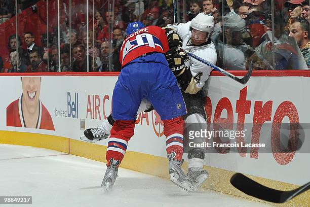 Maxim Lapierre of the Montreal Canadiens collides with Jordan Leopold of the Pittsburgh Penguins in Game Three of the Eastern Conference Semifinals...