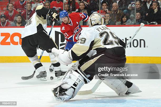 Brian Gionta of the Montreal Canadiens takes a shot on goalie Marc-Andre Fleury of the Pittsburgh Penguins in Game Three of the Eastern Conference...