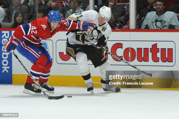 Dominic Moore of the Montreal Canadiens battles for the puck with Evgeni Malkin of the Pittsburgh Penguins in Game Three of the Eastern Conference...