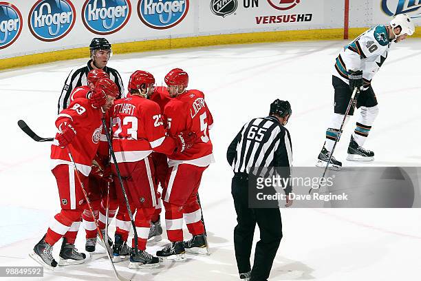 Tomas Holmstrom of the Detroit Red Wings celebrates his goal with teammates Johan Franzen, Brad Stuart and Nicklas Lidstrom as Kent Huskins of the...