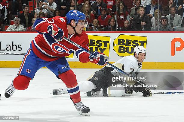 Mike Cammalleri of the Montreal Canadiens takes a shot in front of Mark Eaton of the Pittsburgh Penguins in Game Three of the Eastern Conference...