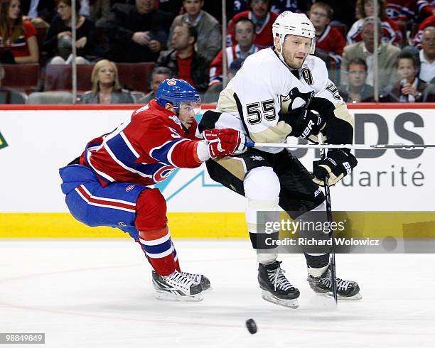 Sergei Gonchar of the Pittsburgh Penguins passes the puck while being chased by Mike Cammalleri of the Montreal Canadiens in Game Three of the...