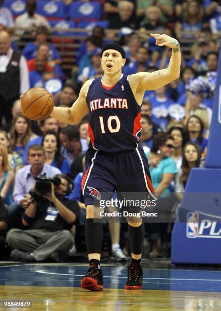 Mike Bibby of the Atlanta Hawks calls out a play while bringing the ball up-court against the Orlando Magic in Game One of the Eastern Conference...