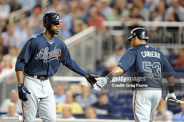 Jason Heyward of the Atlanta Braves is congratulated by Melky Cabrera after hitting a home run in the fourth inning against the Washington Nationals...