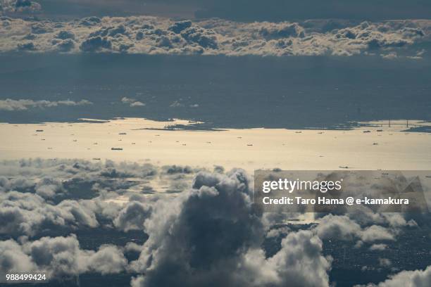 many ships sailing on tokyo bay and yokohama city in kanagawa prefecture in japan sunset time aerial view from airplane - yokohama brücke stock-fotos und bilder