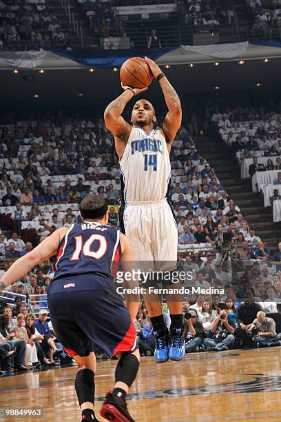 Jameer Nelson of the Orlando Magic shoots against Mike Bibby of the Atlanta Hawks in Game One of the Eastern Conference Semifinals during the 2010...