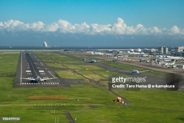 the airplane waiting for taking off on "c" runaway of tokyo haneda international airport in japan daytime aerial view from airplane - tokyo international airport stock pictures, royalty-free photos & images