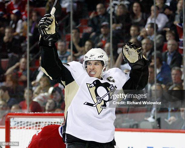 Sidney Crosby of the Pittsburgh Penguins celebrates the third period goal by Evgeni Malkin in Game Three of the Eastern Conference Semifinals during...