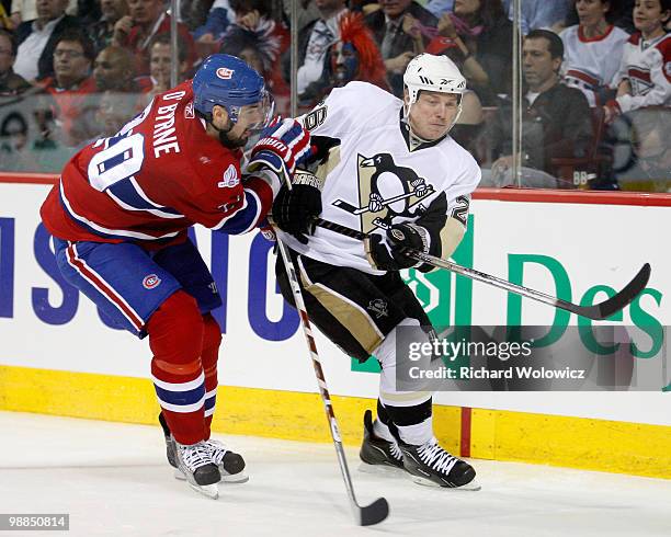 Ryan O'Byrne of the Montreal Canadiens and Ruslan Fedotenko of the Pittsburgh Penguins chase the puck into the corner in Game Three of the Eastern...