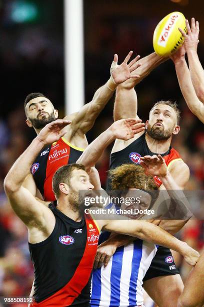 Adam Saad Cale Hooker and Tom Bellchambers of the Bombers competes for the ball against Ben Brown of the Kangaroos during the round 15 AFL match...