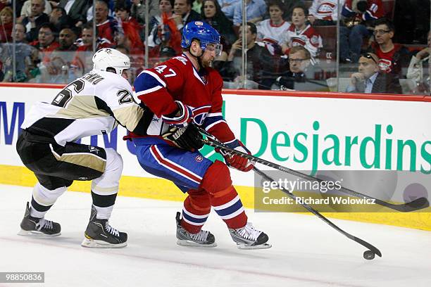 Marc-Andre Bergeron of the Montreal Canadiens stick handles the puck while being chased by Ruslan Fedotenko of the Pittsburgh Penguins in Game Three...