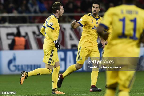 Juventus' Federico Bernardeschi cheers with his teammate Sami Khedira after his score during the Champions League group match between Olympiacos...