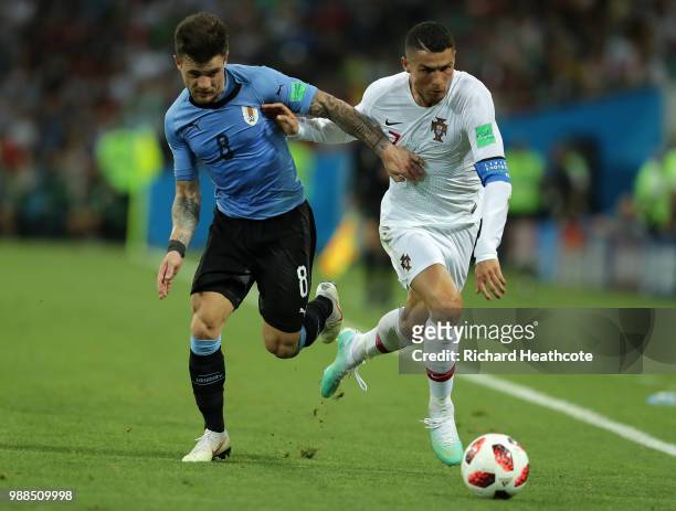 Nahitan Nandez of Uruguay battles for possession with Cristiano Ronaldo of Portugal during the 2018 FIFA World Cup Russia Round of 16 match between...