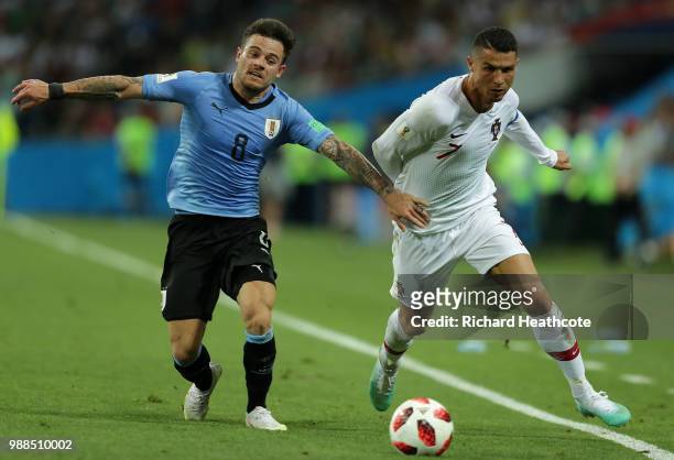 Nahitan Nandez of Uruguay battles for possession with Cristiano Ronaldo of Portugal during the 2018 FIFA World Cup Russia Round of 16 match between...