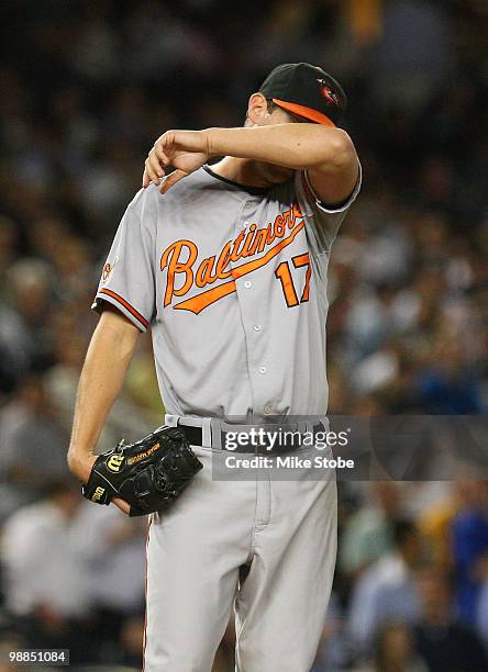 Brian Matusz of the Baltimore Orioles wipes the sweat from his forehead during their game against the New York Yankees at Yankee Stadium on May 4,...