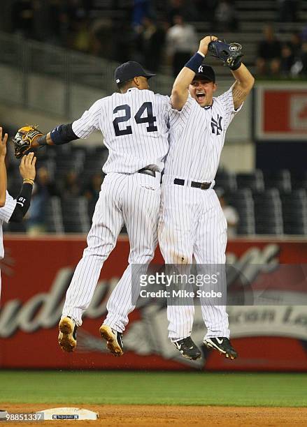 Robinson Cano and Nick Swisher of the New York Yankees celebrate after defeating the Baltimore Orioles 4-1 at Yankee Stadium on May 4, 2010 in the...
