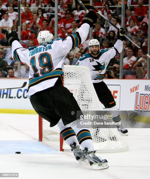 Patrick Marleau of the San Jose Sharks celebrates his overtime game-winning goal with teammate Joe Thornton who assisted on the goal against the...