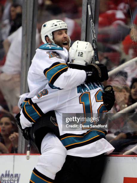 Patrick Marleau of the San Jose Sharks celebrates his overtime game-winning goal with teammate Joe Thornton who assisted on the goal against the...