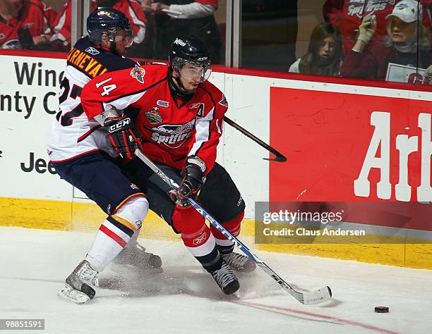 Adam Henrique of the Windsor Spitfires battles Taylor Carnevale of the Barrie Colts for puck possession in the fourth game of the OHL Championship...