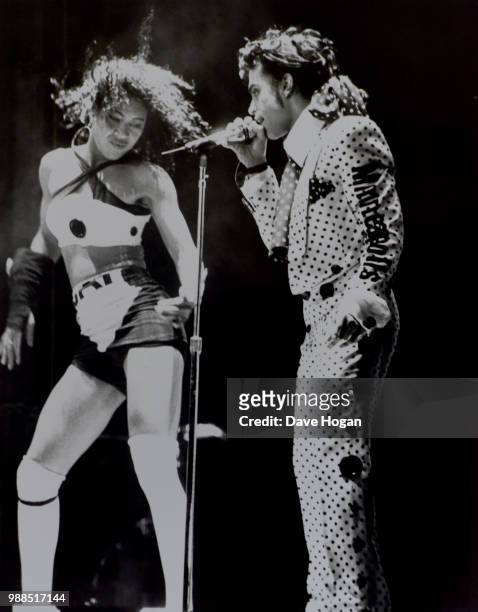 Singer Prince performs with dancer on stage during Wembley Arena concert in London, 1988.