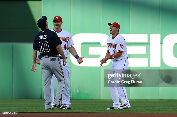 Adam Dunn and Ryan Zimmerman of the Washington Nationals talk with Chipper Jones of the Atlanta Braves before the game at Nationals Park on May 4,...