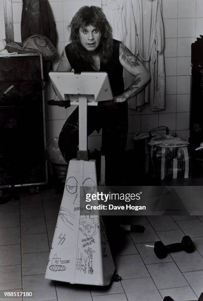 Singer Ozzy Osbourne poses for a portrait on an exercise bike, circa 1985.
