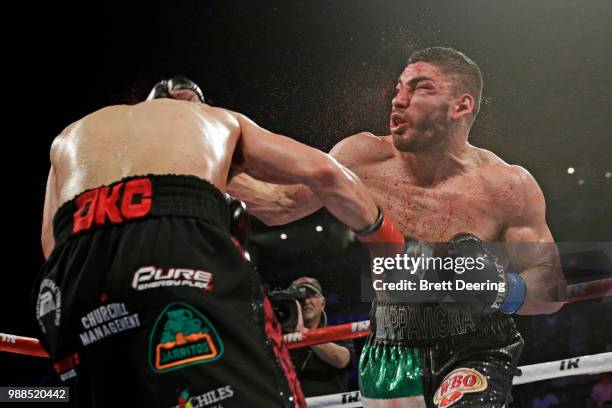 Junior welterweight Alex Saucedo, left, lands an overhand right on Leonardo Zappavigna at Chesapeake Energy Arena on June 30, 2018 in Oklahoma City,...