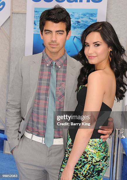 Singers Joe Jonas of The Jonas Brothers and singer/actress Demi Lovato attend the premiere of "Oceans" at the El Capitan Theatre on April 17, 2010 in...