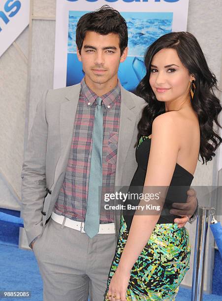 Singers Joe Jonas of The Jonas Brothers and singer/actress Demi Lovato attend the premiere of "Oceans" at the El Capitan Theatre on April 17, 2010 in...
