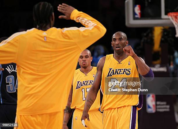 Kobe Bryant of the Los Angeles Lakers reacts during a timeout with teammate Josh Powell while taking on the Utah Jazz during Game Two of the Western...