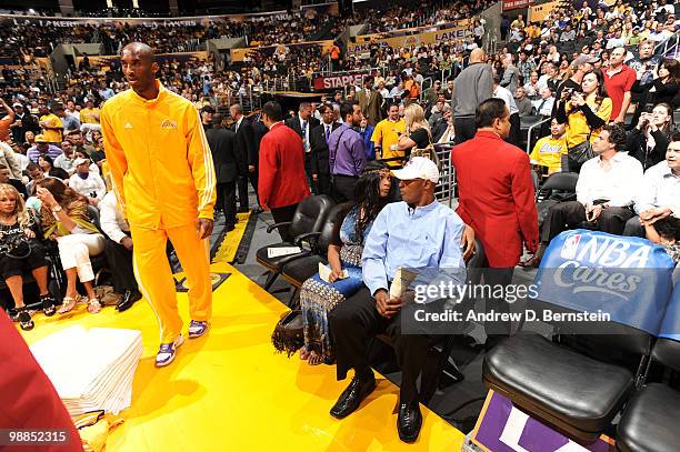 Kobe Bryant of the Los Angeles Lakers takes the court while his parents Pam Bryant and Joe Bryant look on before a game against the Utah Jazz in Game...
