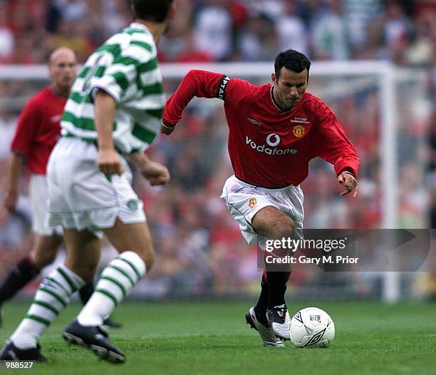 Ryan Giggs of Man Utd goes past Jackie McNamara of Celtic during the Manchester United v Celtic Ryan Giggs Testimonial match at Old Trafford,...