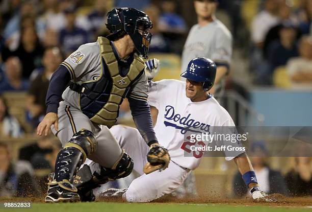 Casey Blake of the Los Angeles Dodgers slides safely past catcher Gregg Zaun of the Milwaukee Brewers in the fifth inning at Dodger Stadium on May 4,...