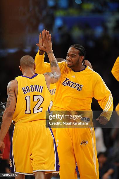 Shannon Brown and Josh Powell of the Los Angeles Lakers slap hands during their game against the Utah Jazz in Game Two of the Western Conference...