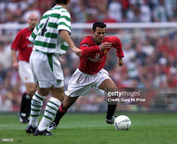 Ryan Giggs of Man Utd goes past Jackie McNamara of Celtic during the Manchester United v Celtic Ryan Giggs Testimonial match at Old Trafford,...